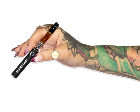 Hand holding a vaping device with 'Maryjae' branding on a white background